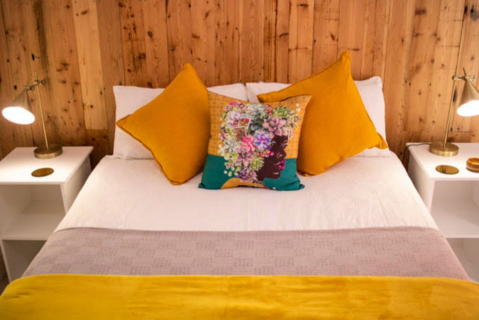 Bed dressed in mustard and teal